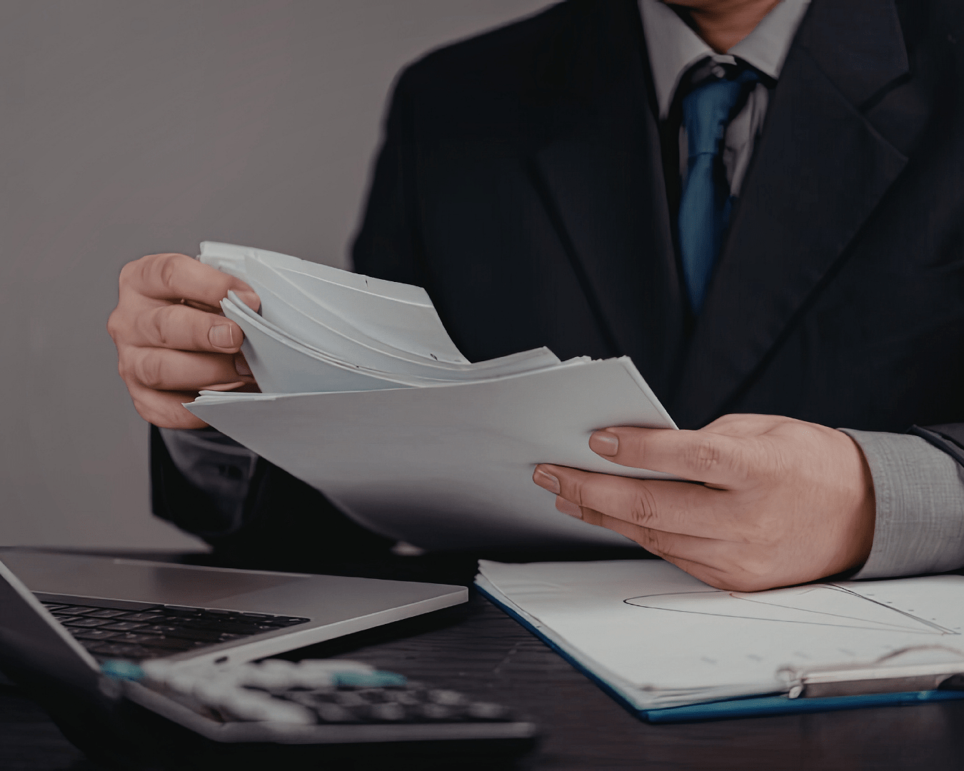 business owner reviewing financial documents and planning tax strategy at a clean organized desk