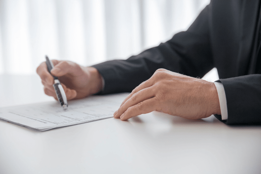 Businessman signing legal paperwork, representing LLC operating agreements and entity documentation