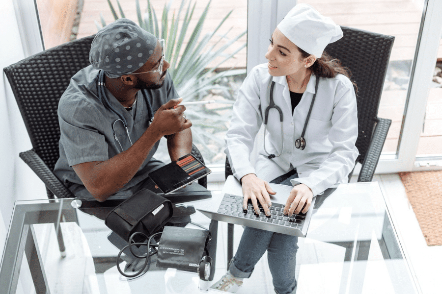 Two dental partners in a clinic reviewing documents to ensure their partner lawsuit practice structure is legally secure 
