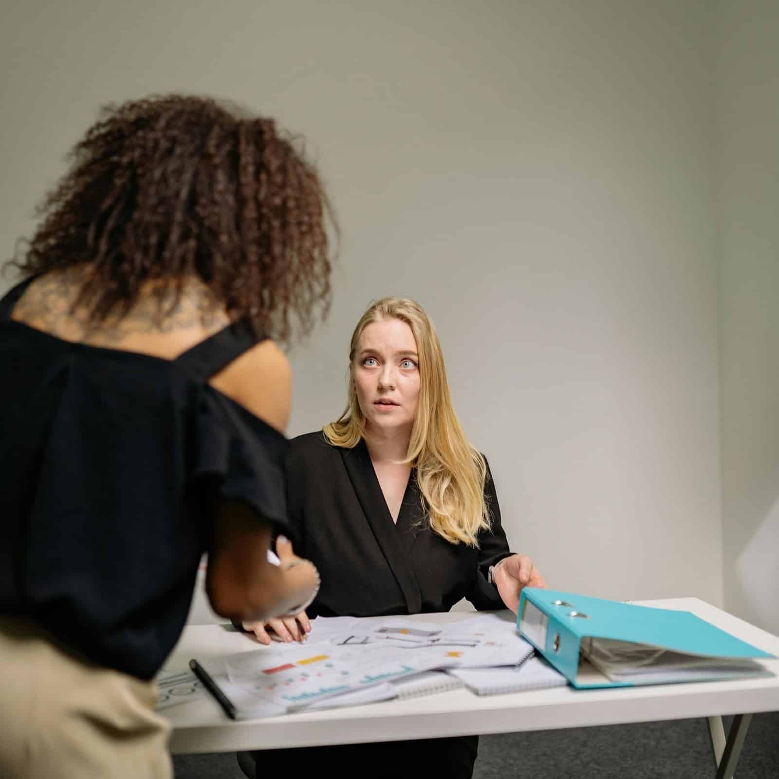 Physician and business owner reviewing estate planning documents with a financial advisor.