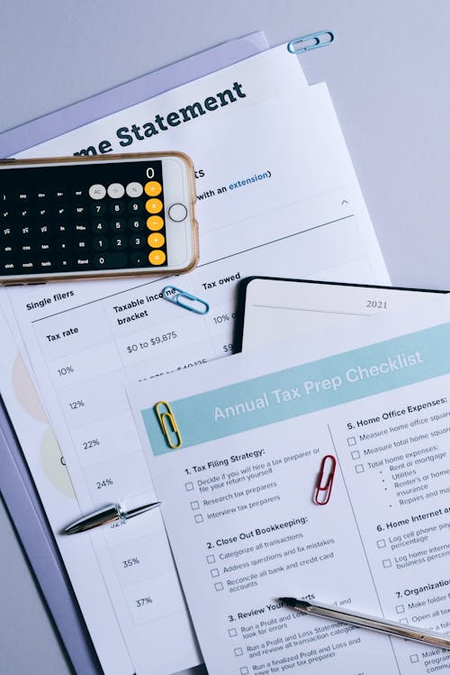 Image of a calculator and annual tax prep checklist.