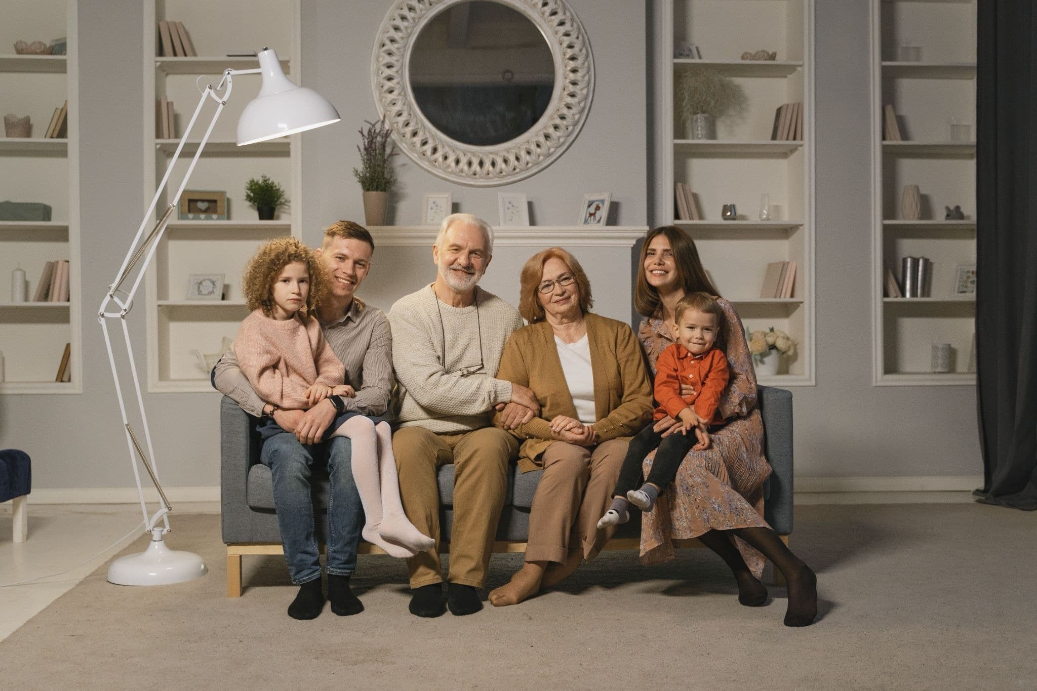 Multi-generational family sitting together at home, representing estate planning for real estate investors
