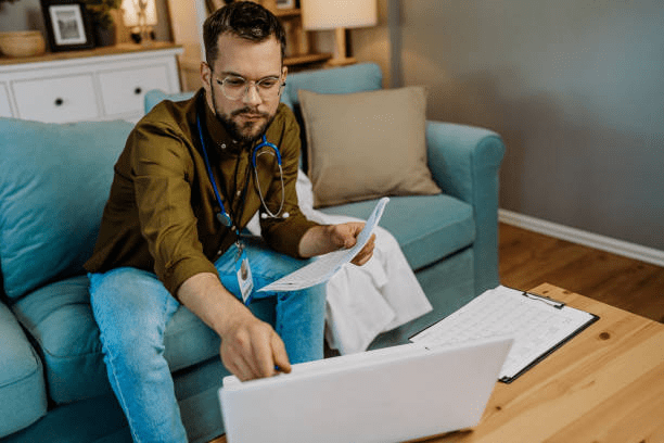A medical professional having a zoom meeting in their home.]