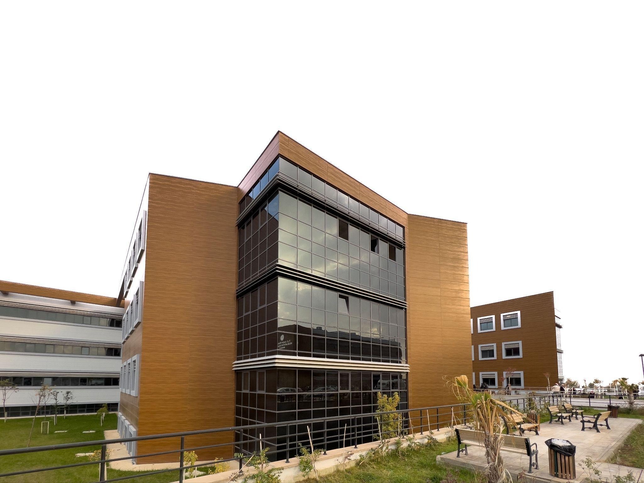 Exterior of a multi-story medical office building with adjoining wings and a landscaped walkway
