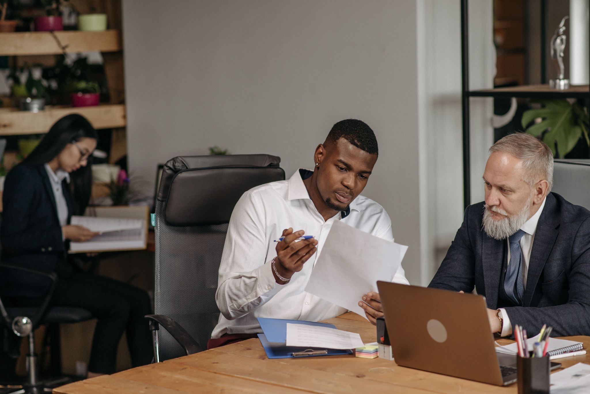 Two professionals reviewing documents at a desk