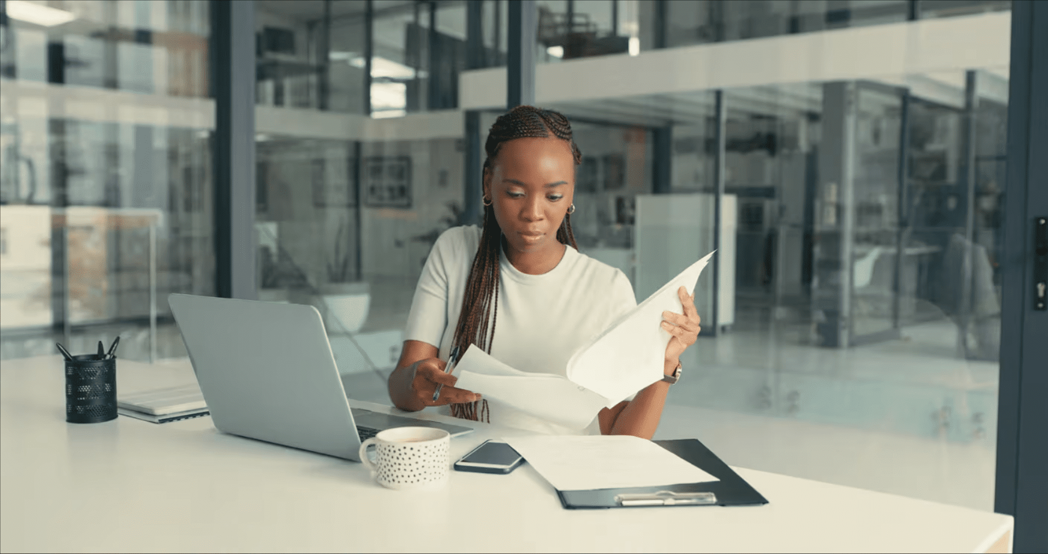 Physician reviewing financial and estate planning documents at a desk in a modern office